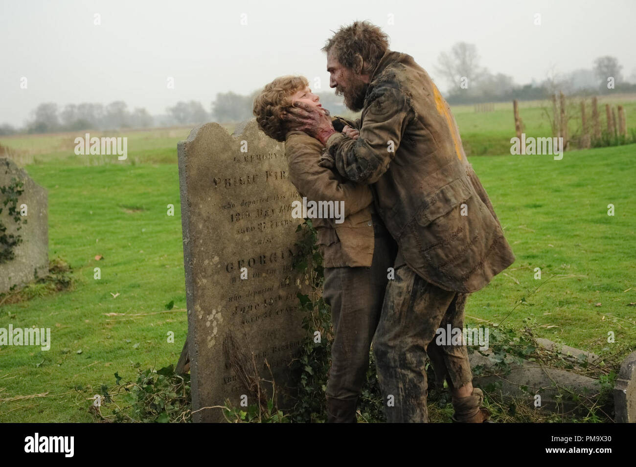 Toby Irvine stars as Young Pip and Jason Flemyng stars as Joe Gargery in Outsource Media Group's Great Expectations (2012) Stock Photo