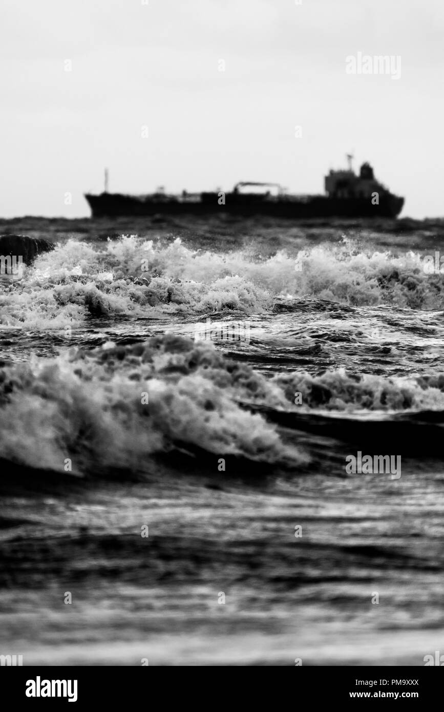 Ship in the stormy sea waves Stock Photo