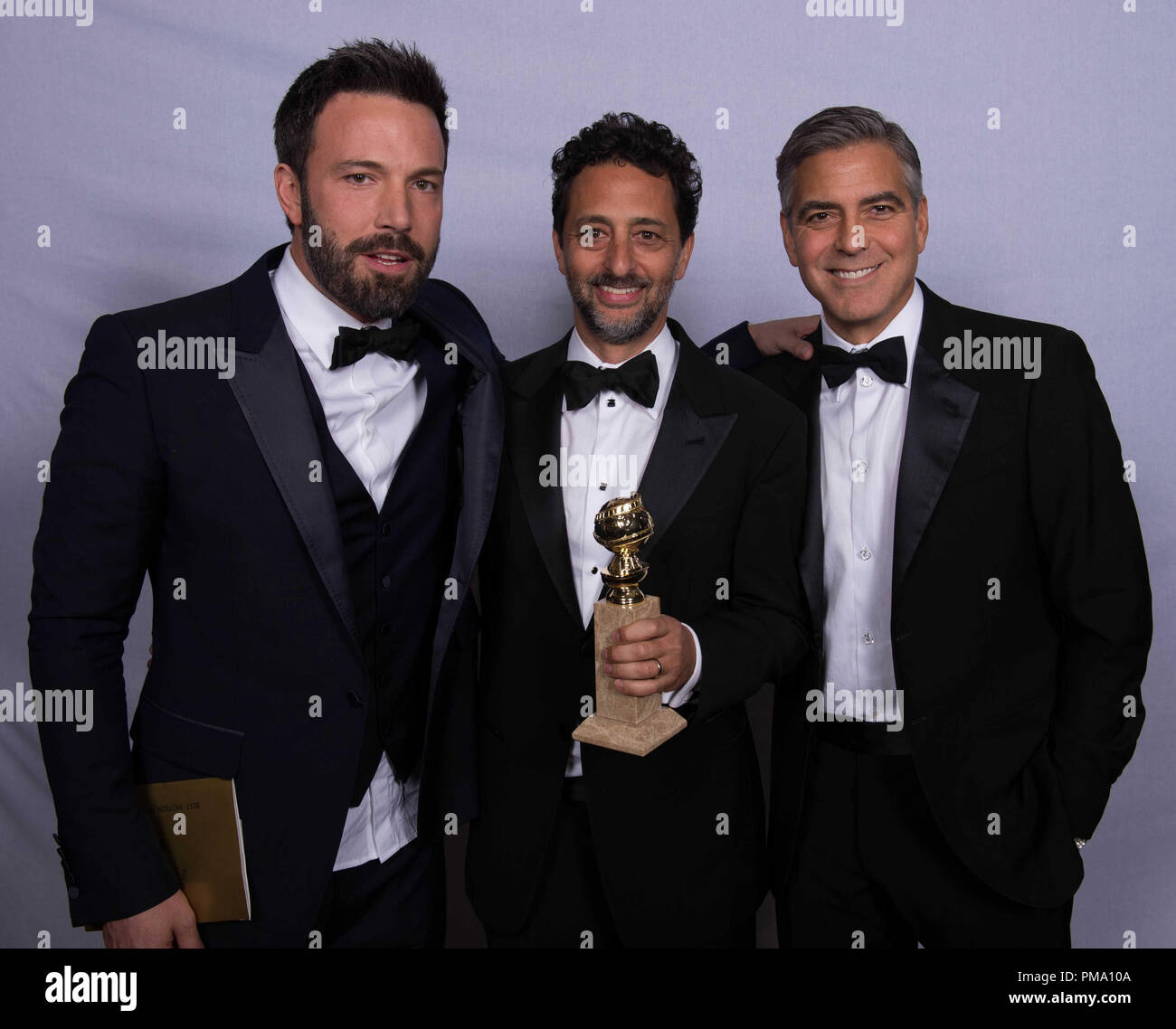 For BEST MOTION PICTURE – DRAMA, the Golden Globe is awarded to “ARGO”, produced by Warner Bros. Pictures, GK Films, Smokehouse Pictures; Warner Bros. Pictures. producers Ben Affleck, Grant Heslov and George Clooney pose with the award backstage in the press room at the 70th Annual Golden Globe Awards at the Beverly Hilton in Beverly Hills, CA on Sunday, January 13, 2013. Stock Photo