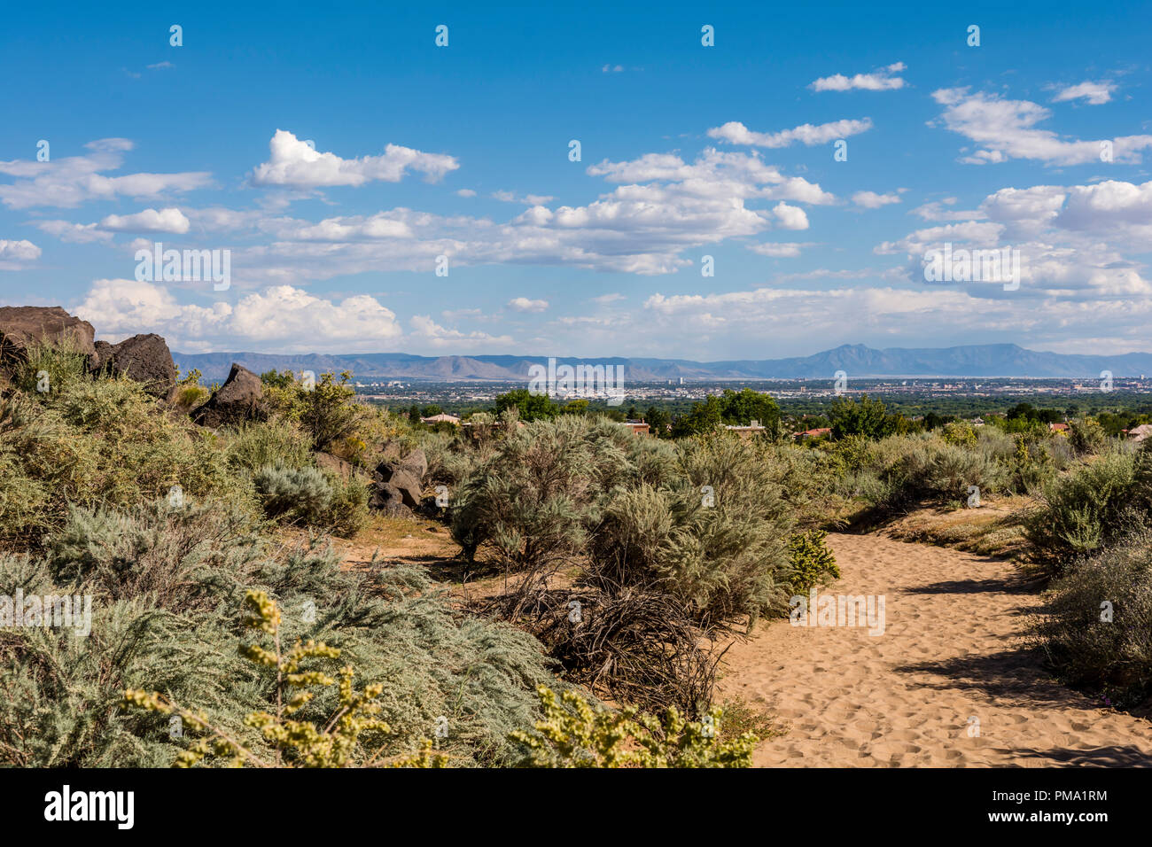 Albuquerque city view, landscape and Sandia Mountains from Piedras Marcadas Canyon trail in Petroglyph National Monument, New Mexico USA Stock Photo