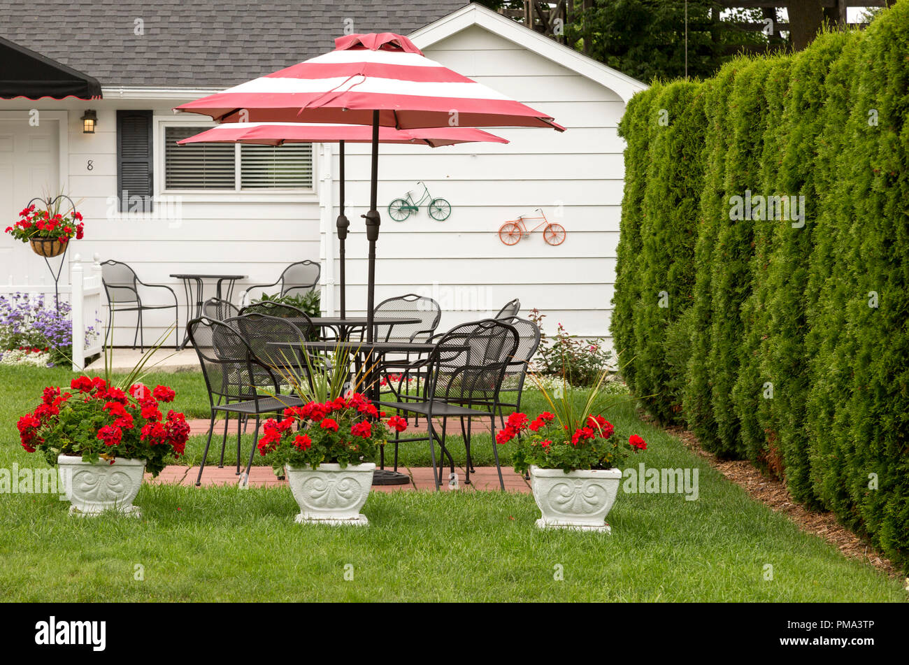 Red And White Umbrella On Wrought Iron Patio Set Outside A Bed And Breakfast Inn On Mackinac Island Michigan In The Midwest Of The United States Stock Photo Alamy