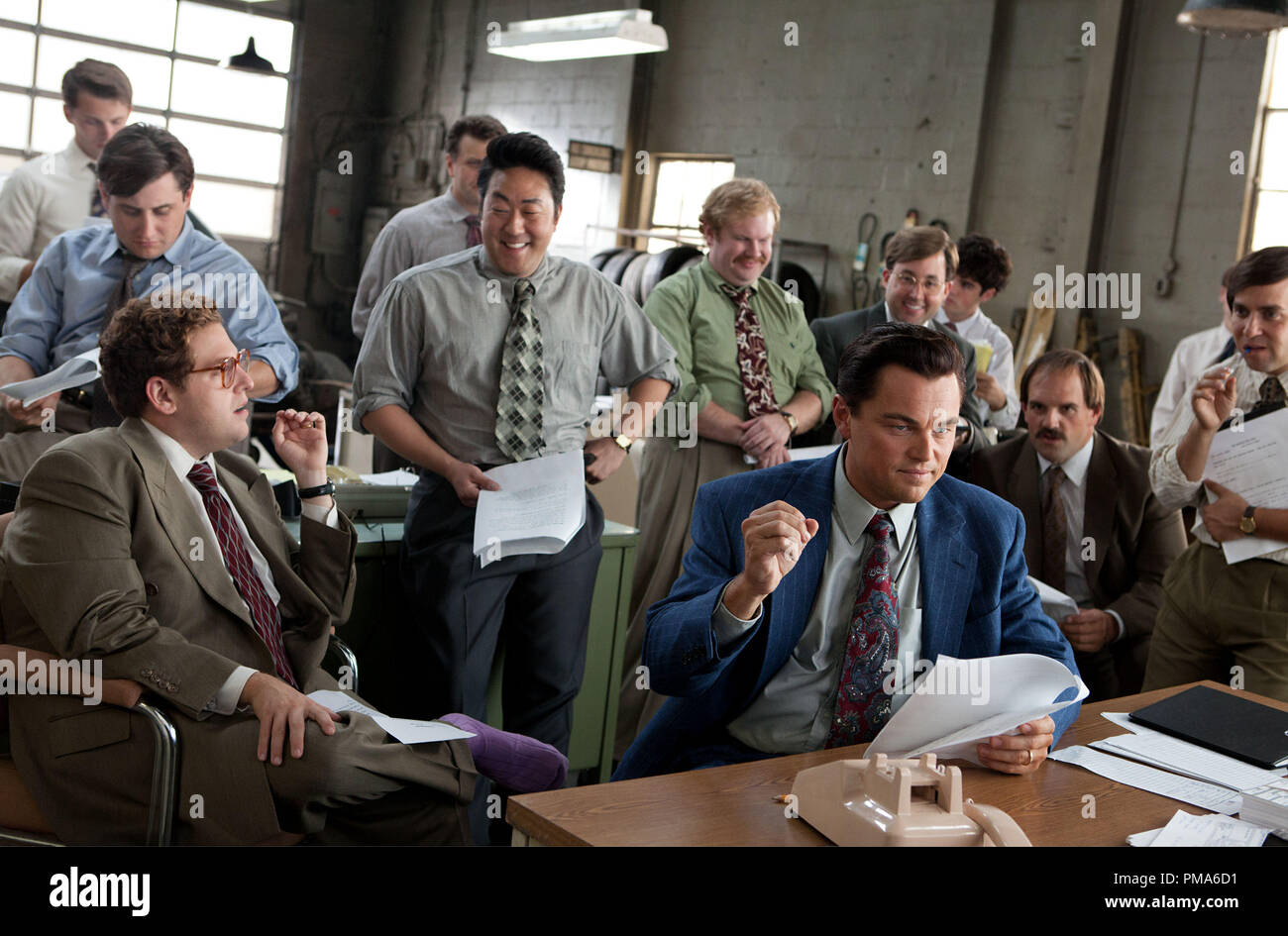 Foreground left to right: Jonah Hill is Donnie Azoff, Kenneth Choi is  Chester Ming, Leonardo DiCaprio is Jordan Belfort, Henry Zebrowski is Alden  Kupferberg ("Sea Otter"), P.J. Bryne is Nicky Koskoff ("Rugrat"),