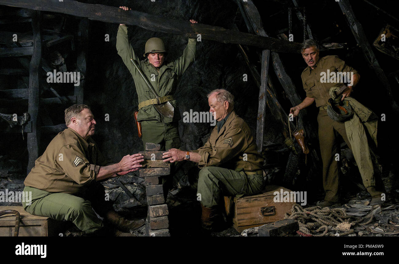 (l to r) Walter Garfield (JOHN GOODMAN), James Granger (MATT DAMON), Richard Campbell (BILL MURRAY), and Frank Stokes (GEORGE CLOONEY) work to put weight on a 'booby trap' that James Granger has stepped on in Columbia Pictures' THE MONUMENTS MEN. (2014) Stock Photo
