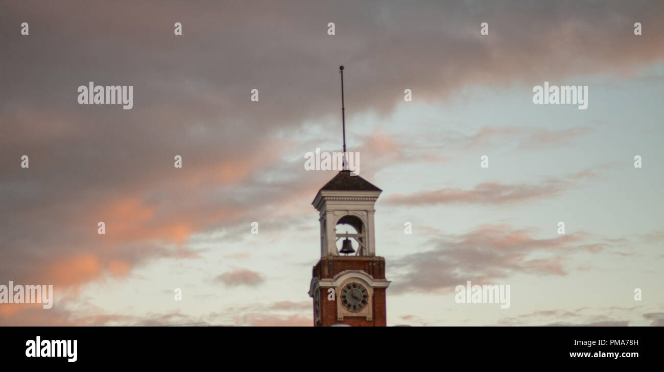 a clock tower at dusk and clouds rolling in. Stock Photo