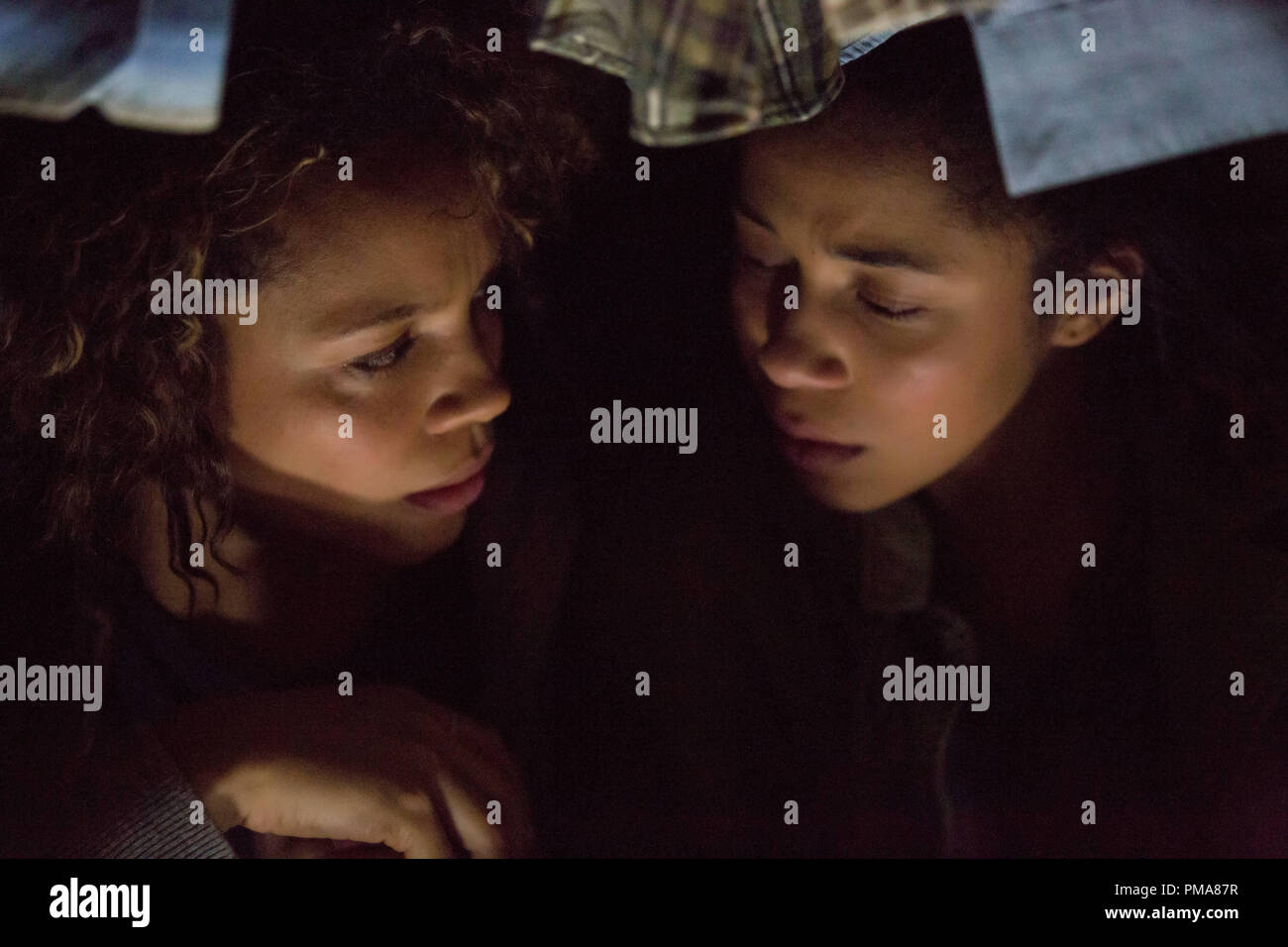 (L to R) Eva (CARMEN EJOGO) hides with daughter Cali (ZOE SOUL) in "The