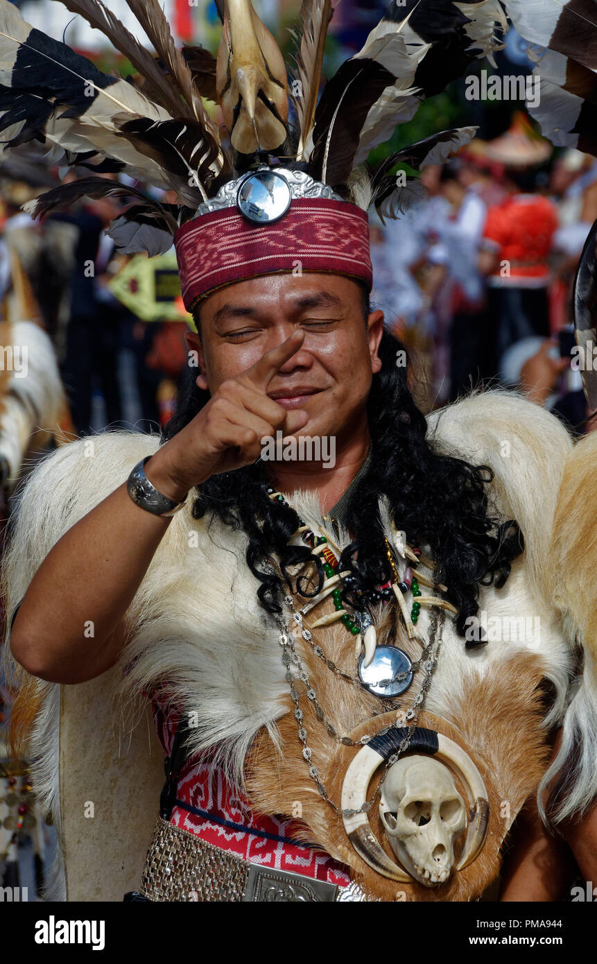 Iban warriors at the Gawai parade with traditional headdress, feathers and costume, Kuching, Sarawak, Malaysia, Borneo Stock Photo