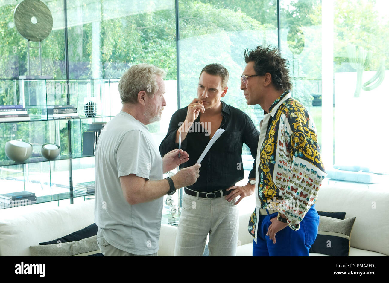 Director Ridley Scott (left) discusses a scene with Michael Fassbender and Javier Bardem on the set of THE COUNSELOR. Stock Photo