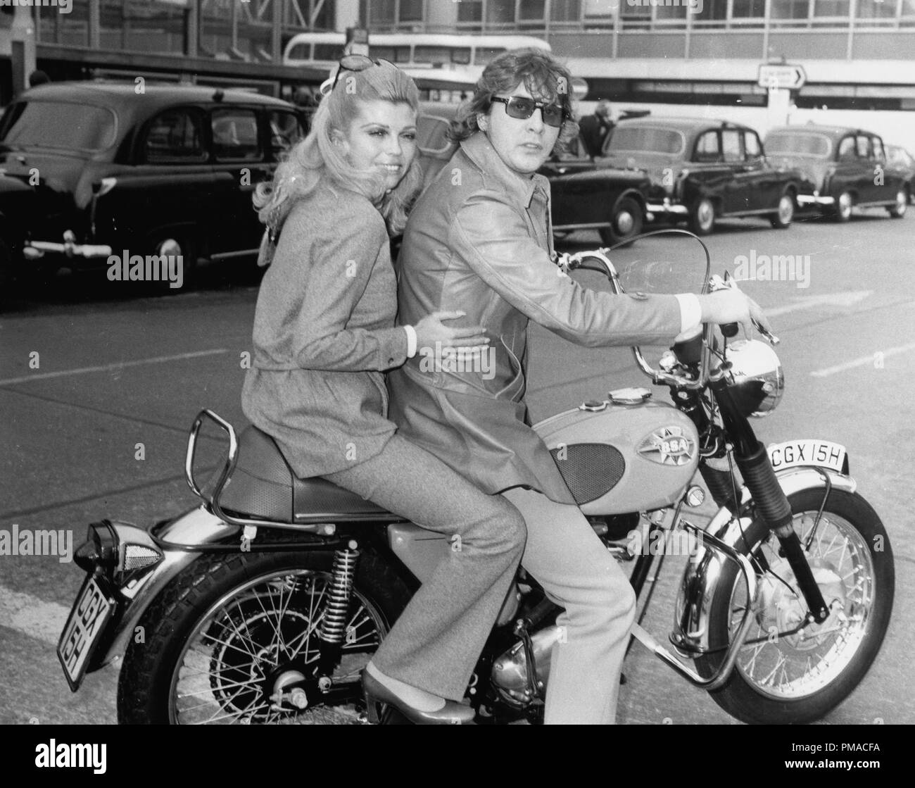 Nancy Sinatra on a motorcycle with Mickie Most, 1969 © JRC /The Hollywood Archive - All Rights Reserved  File Reference # 32368 198THA Stock Photo