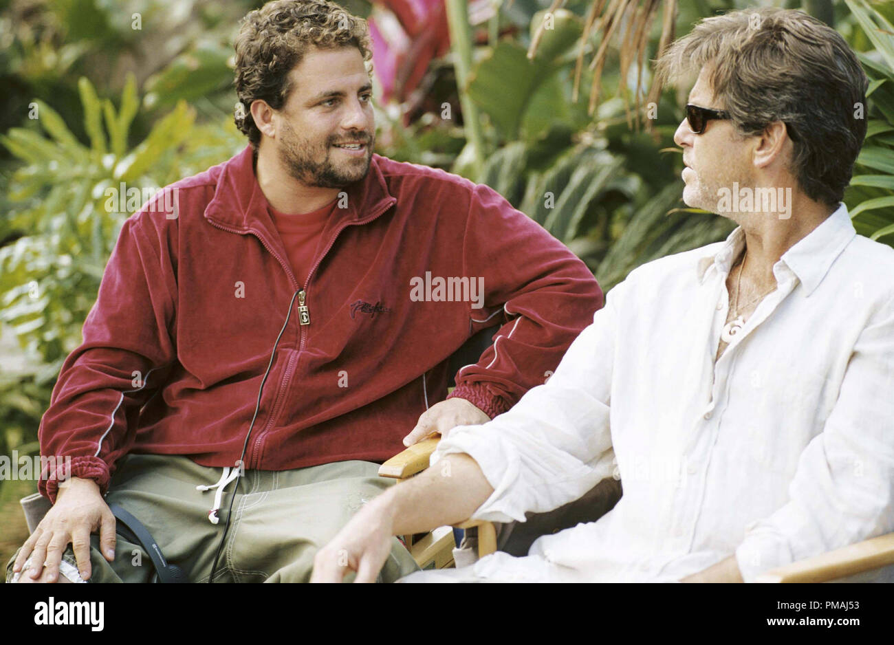 Director Brett Ratner with Pierce Brosnan between takes on the set of New Line Cinema's film After The Sunset. (2004) Stock Photo