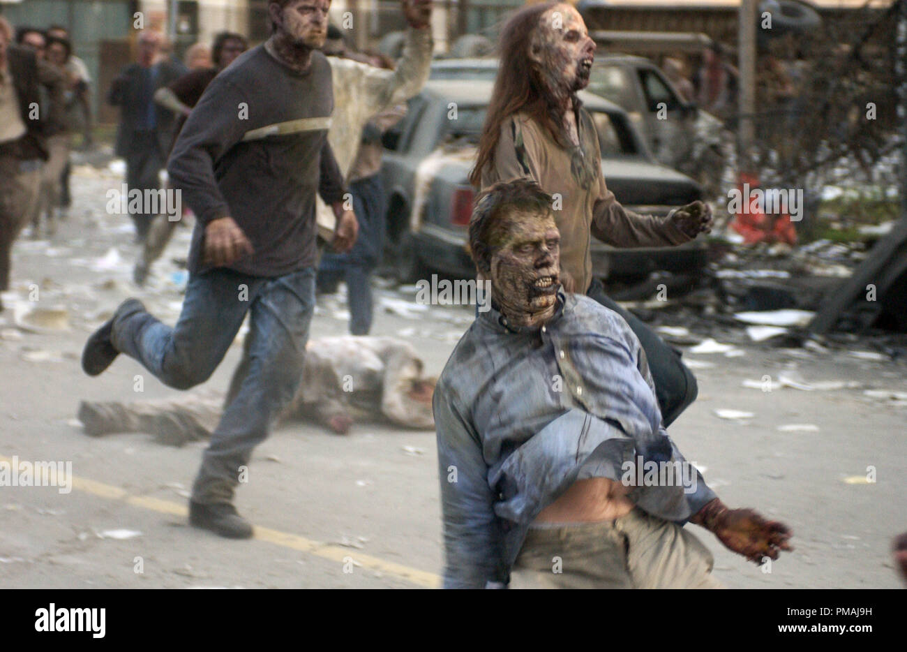 A pursuing zombie goes from undead to dead in the zombie action thriller, Dawn of the Dead. (2004) Stock Photo