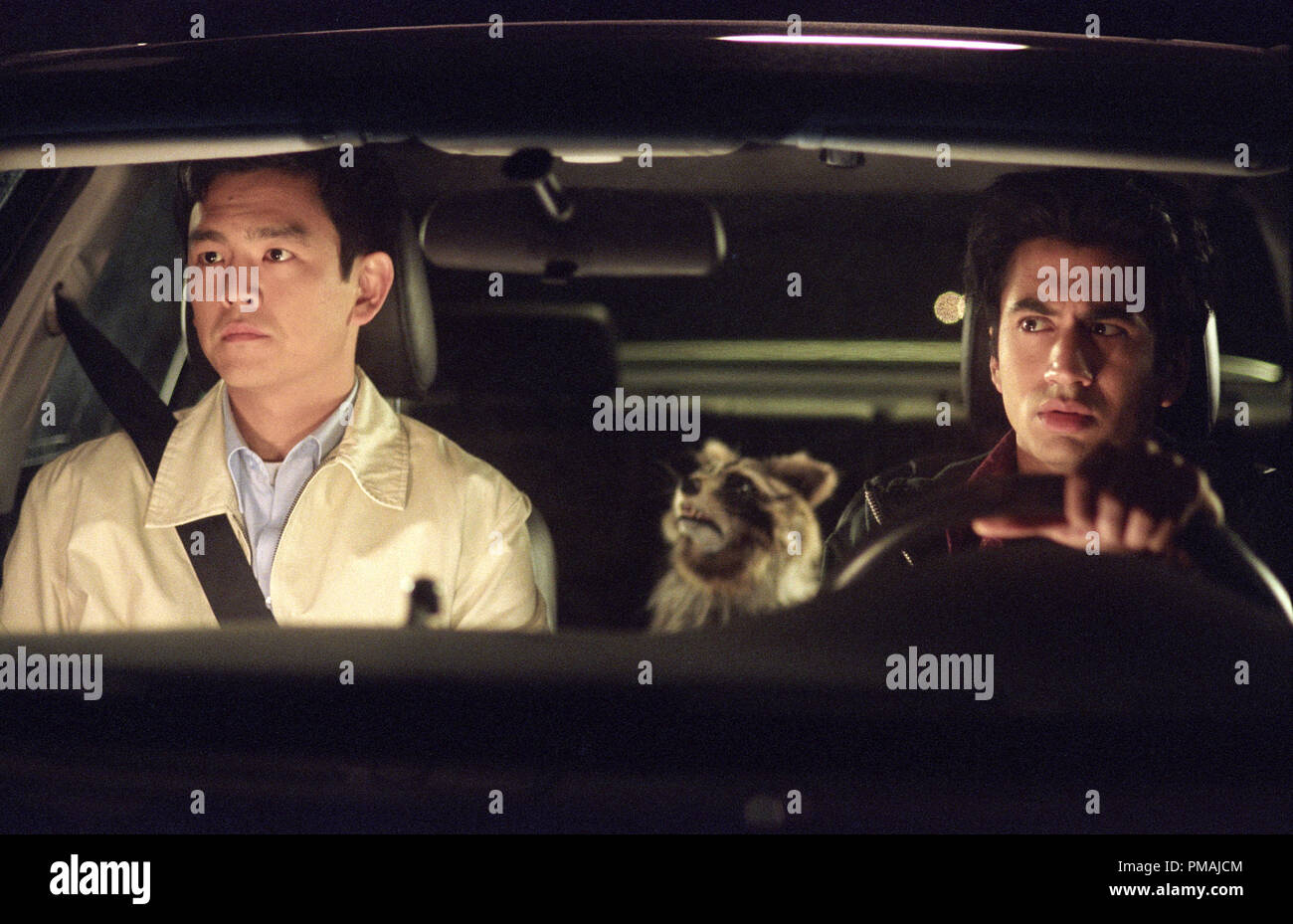 Harold (John Cho, left) and Kumar (Kal Penn, right) sense they have an unexpected passenger in New Line Cinema's comedy, Harold and Kumar Go To White Castle. (2004) Stock Photo