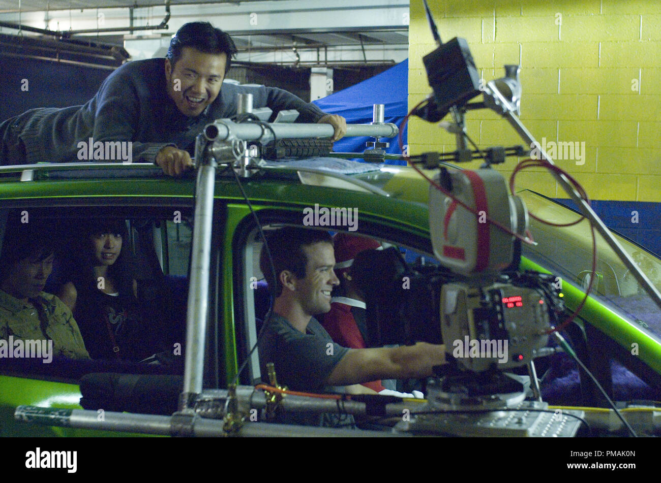 Director JUSTIN LIN hangs on for dear life while LUCAS BLACK as Sean Boswell drives on set  'The Fast and the Furious: Tokyo Drift' (2006) Stock Photo