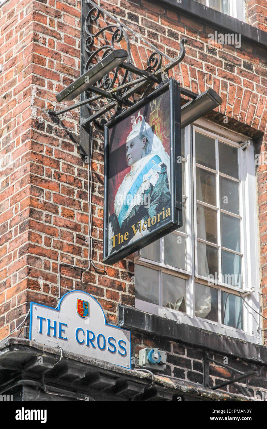 Chester, England - 16th August 2016: Sign for The Victoria Public House and street sign for the Cross. It is a traditional English pub. Stock Photo