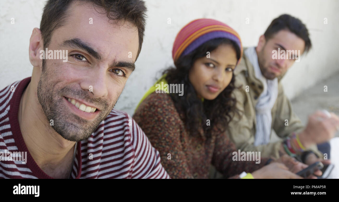 Portrait of Handsome young man smiling with multiracial friends Stock Photo