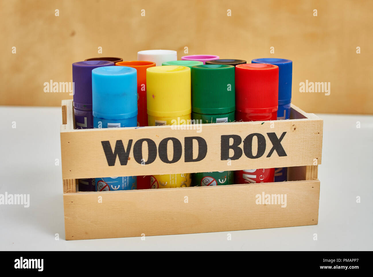 wood box full of big crayons Stock Photo