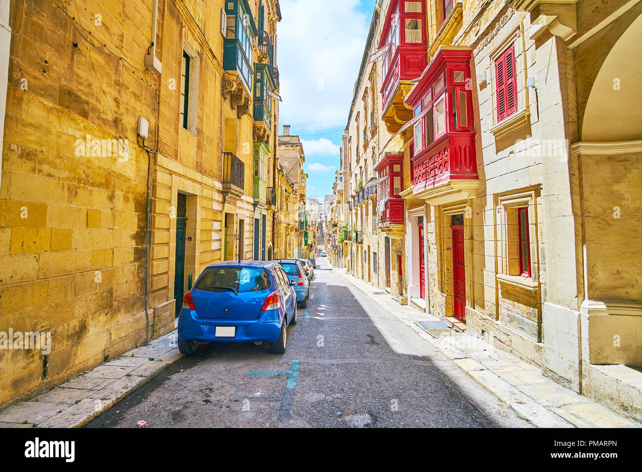 The colored wooden doors, window frames and balconies are traditional decorative elements of Maltese architecture, Valletta. Stock Photo