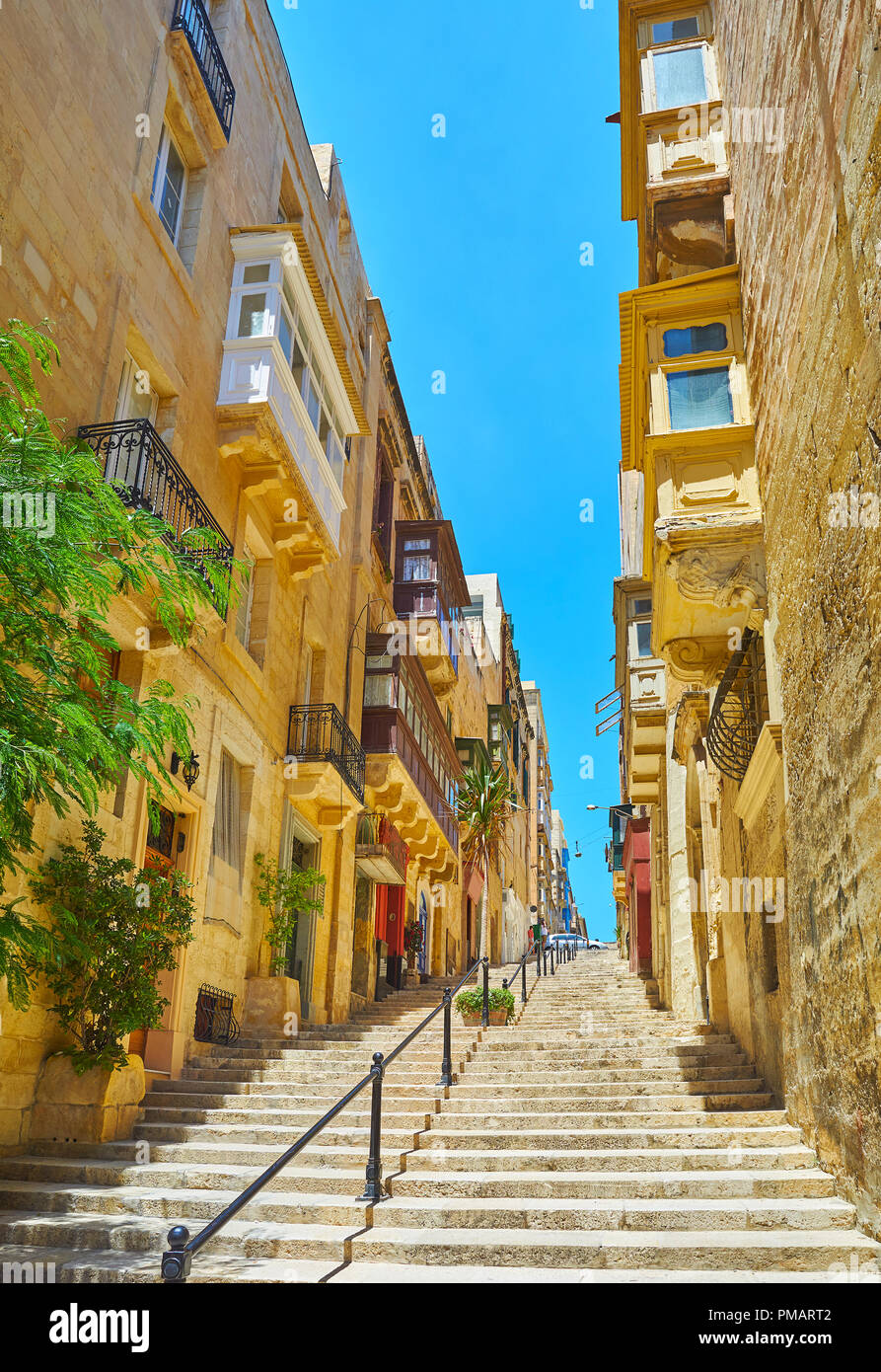 The long way along the steep staircase in St Lucia street, Valletta, Malta. Stock Photo