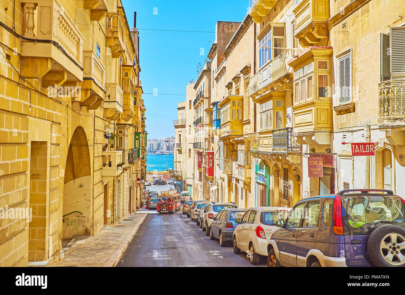 VALLETTA, MALTA - JUNE 17, 2018: The gentle descent of St Lucia's street leads to the sea and ferry terminal of Sliema direction, on June 17 in Vallet Stock Photo