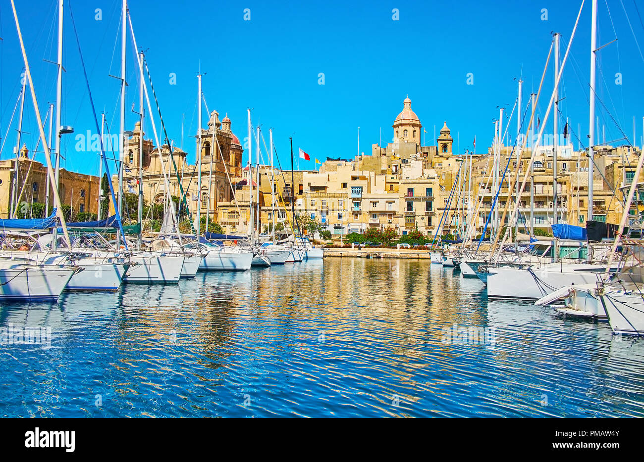 The Vittoriosa Marina opens the view on huge domes of medieval St Lawrence and Annunciation churches in Birgu, Malta. Stock Photo