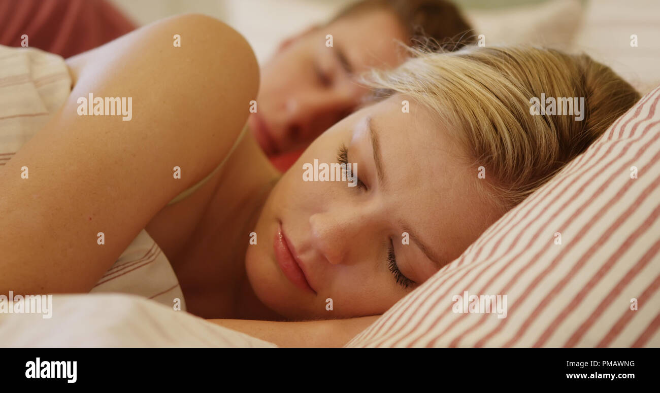 Beautiful young woman sleeping in bed Stock Photo