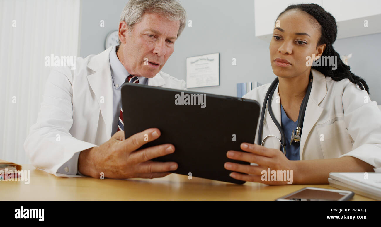 Hardworking doctors reviewing patient's file Stock Photo - Alamy