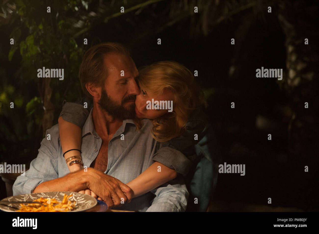 Ralph Fiennes as “Harry Hawkes” and Dakota Johnson as “Penelope Lanier” in A BIGGER SPLASH. © 2015 Twentieth Century Fox Film Corporation All Rights Reserved Stock Photo
