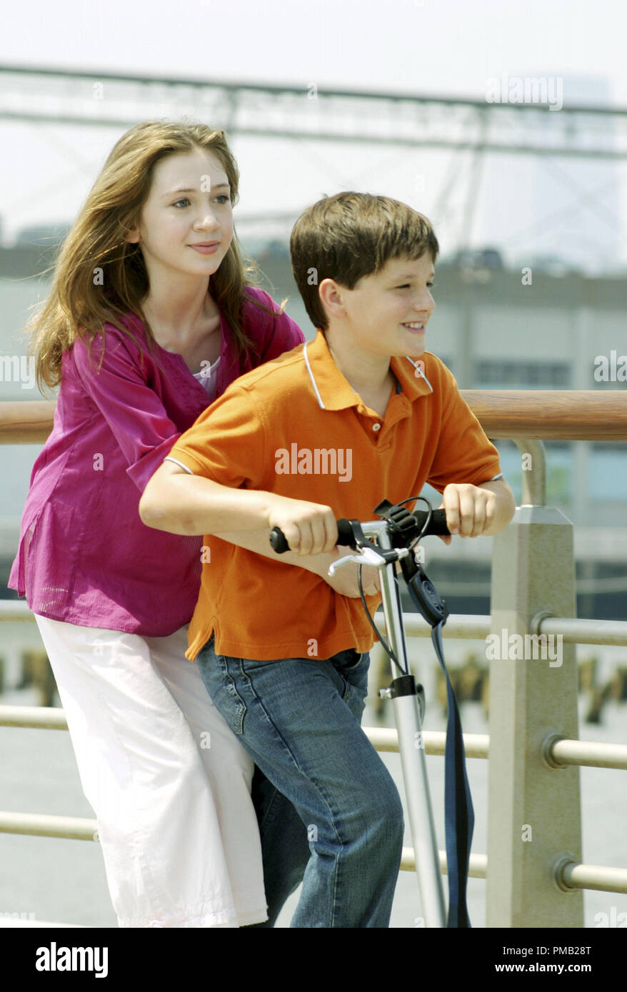 Rosemary (Charlie Ray) and Gabe (Josh Hutcherson) take in the wonders of the most romantic city in the world Ð New York Ð on a scooter, in LITTLE MANHATTAN. (2005) Stock Photo