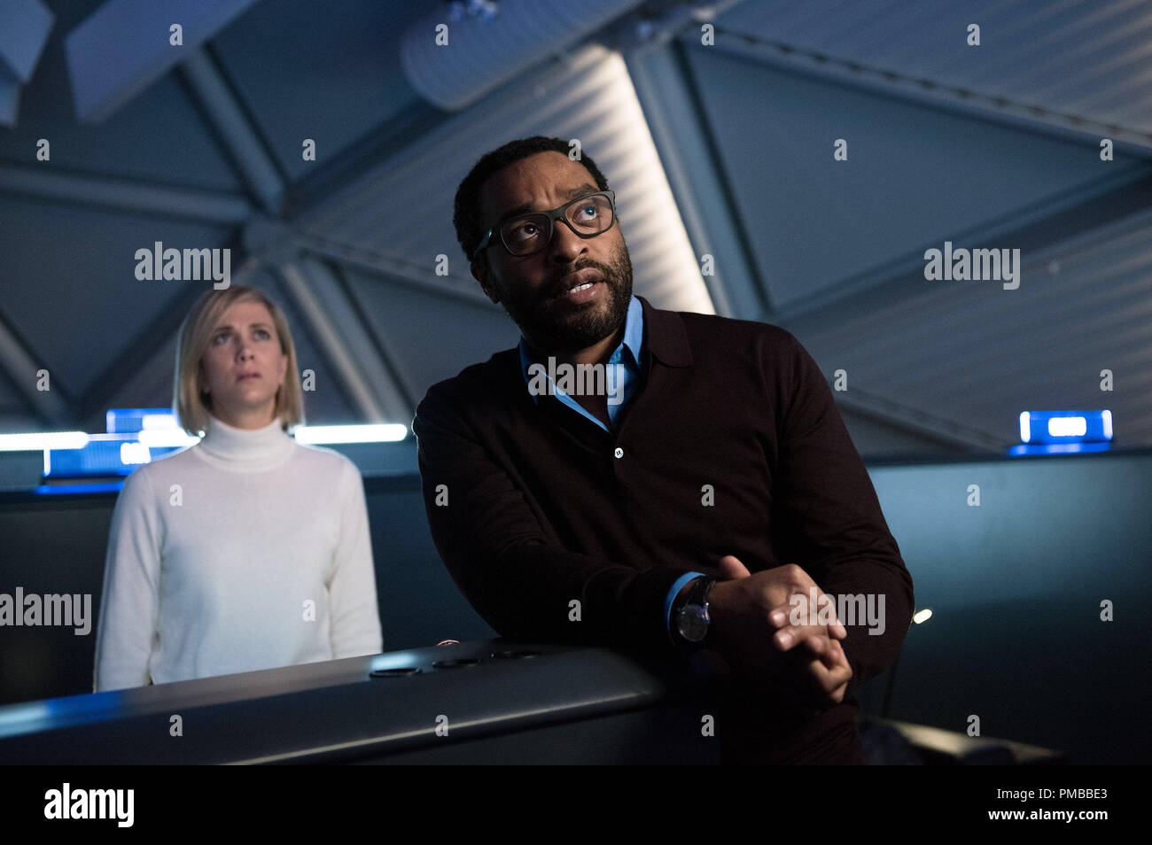 Annie Montrose (Kristin Wiig), NASA's media relations director, and NASA's Director of Mars missions, Dr. Vincent Kapoor (Chiwetel Ejiofor), do everything they can to bring home an astronaut stranded on Mars, in THE MARTIAN. Stock Photo