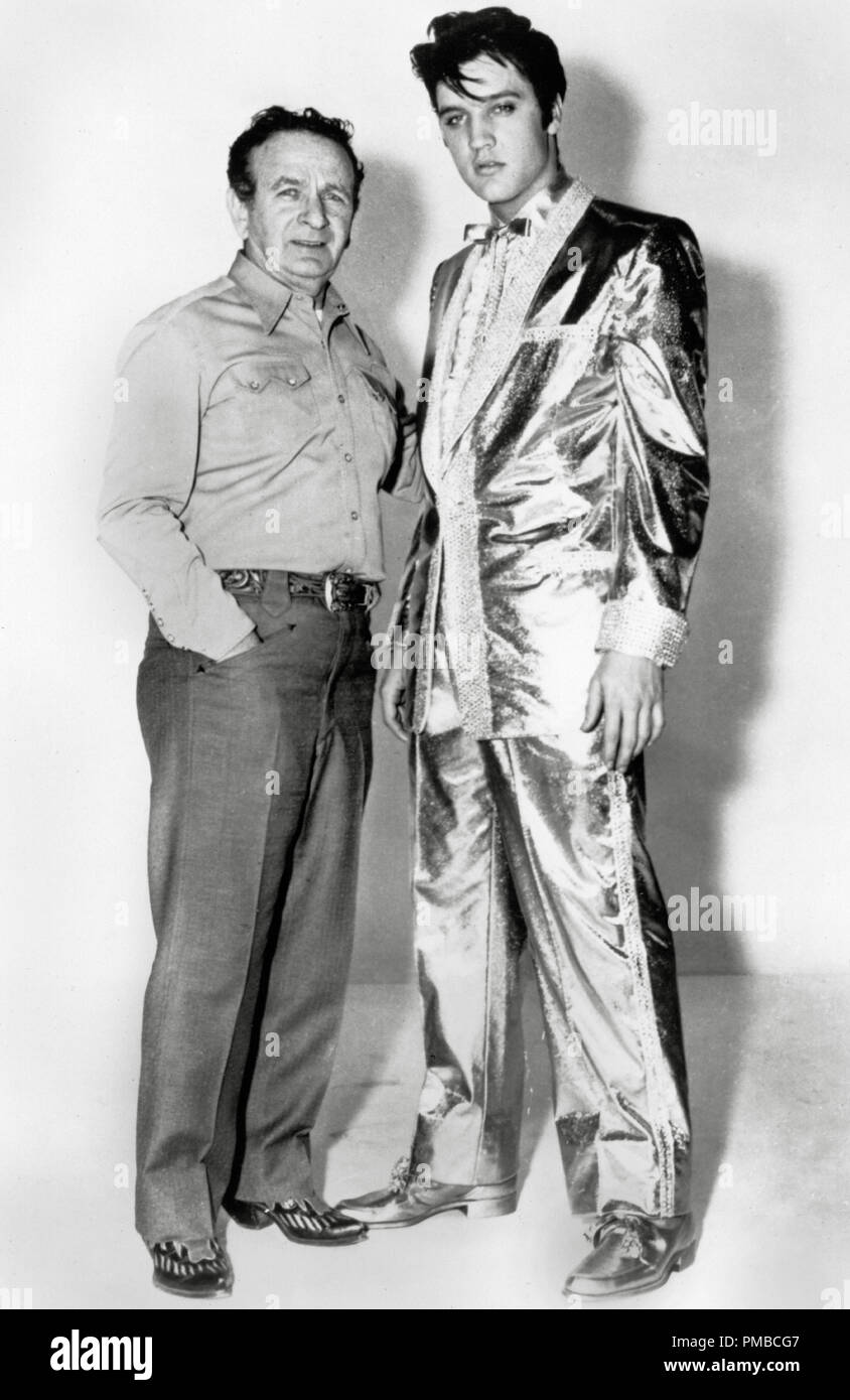 Fashion designer Nudie Cohn and Elvis Presley in his $10,000 gold lamé  suit, worn by the singer on the cover of his "50,000,000 Elvis Fans Can't  Be Wrong" album, circa 1959. File