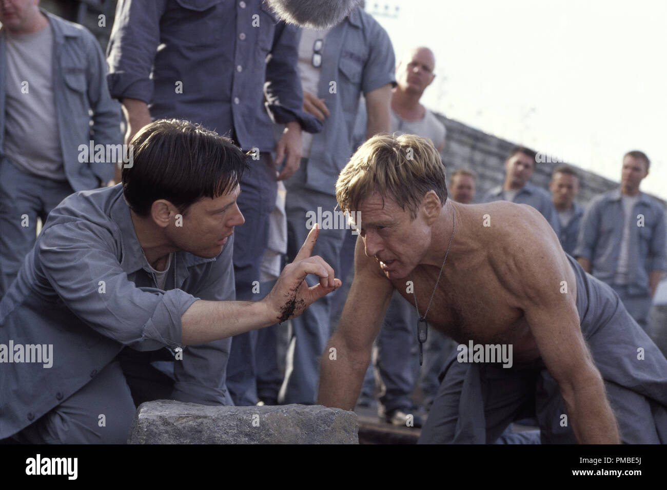 Doc (FRANK MILITARY, left) checks on the condition of Irwin (ROBERT REDFORD) during a grueling punishment in DreamWorks Pictures' THE LAST CASTLE. Stock Photo