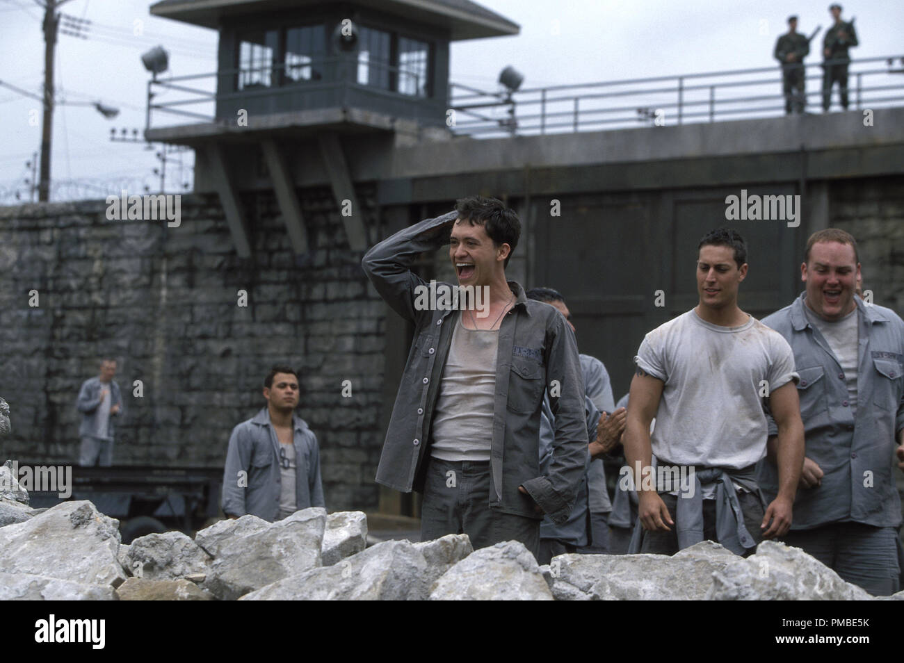 Aguilar (CLIFTON COLLINS, JR., center) and his fellow prisoners destroy the old prison wall as they prepare to start rebuilding it as a team in DreamWorks Pictures' THE LAST CASTLE. Stock Photo