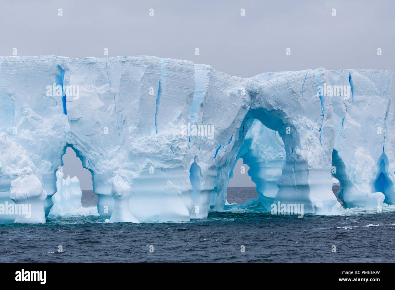 Huge arched iceberg south of the Antarctica Circle, Antarctica. Stock Photo