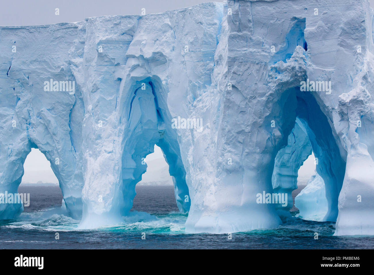 Huge arched iceberg south of the Antarctica Circle, Antarctica. Stock Photo