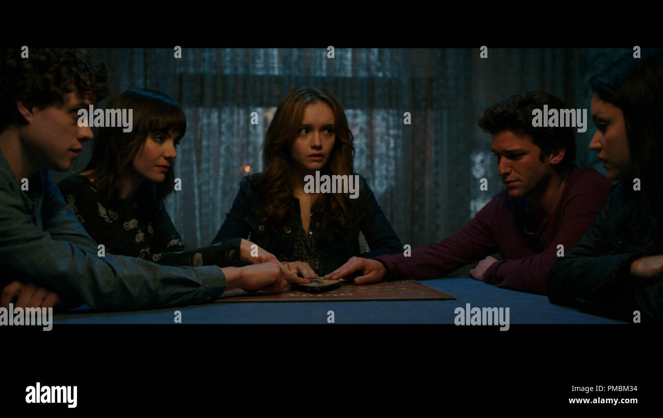 (L to R) Pete (DOUGLAS SMITH), Sarah (ANA COTO), Laine (OLIVIA COOKE), Trevor (DAREN KAGASOFF) and Isabelle (BIANCA SANTOS) in 'Ouija', a supernatural thriller about a group of friends who must confront their most terrifying fears when they awaken the dark powers of an ancient spirit board. Stock Photo