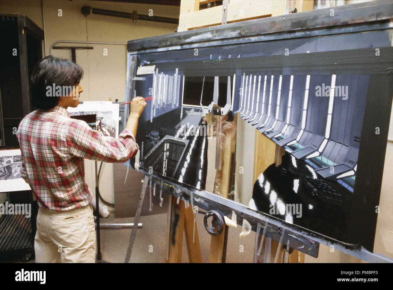 ILM matte artists Frank Ordaz works on a matte painting of the Death Star II hangar for 'Star Wars: Episode VI: Return of the Jedi' (1983)  File Reference # 32603 479THA Stock Photo