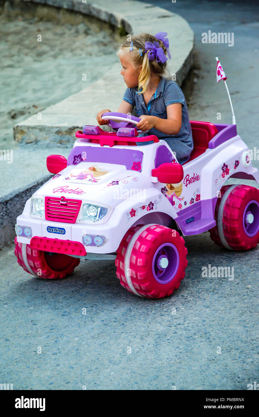 little girl driving barbie car