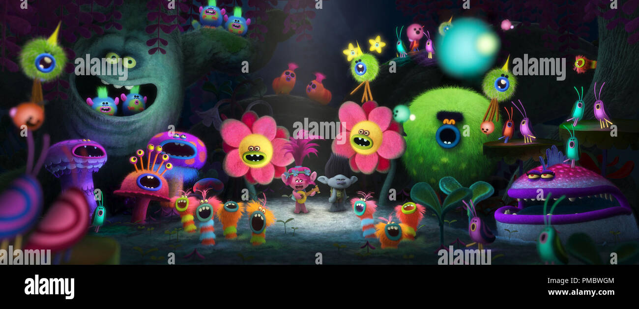 Poppy's (center left with guitar, voiced by Anna Kendrick) rendition of 'The Sounds of Silence' reaches its climax as a grumpy Branch (center right, voiced by Justin Timberlake) looks on in DreamWorks Animation's TROLLS. Stock Photo