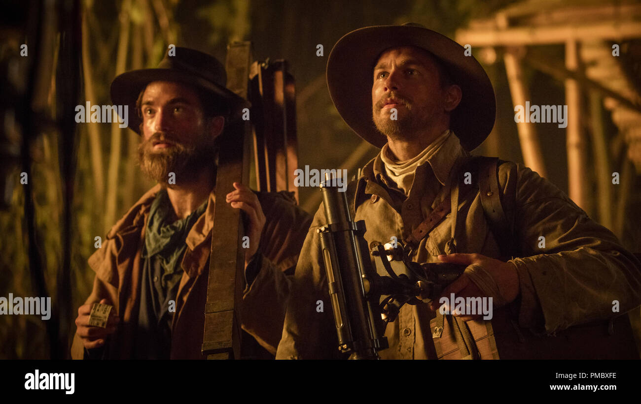 Robert Pattinson (left) stars as Henry Costin and Charlie Hunnam (right) stars as Percy Fawcett in director James Gray's THE LOST CITY OF Z, an Amazon Studios/Bleecker Street release. (2017) Stock Photo