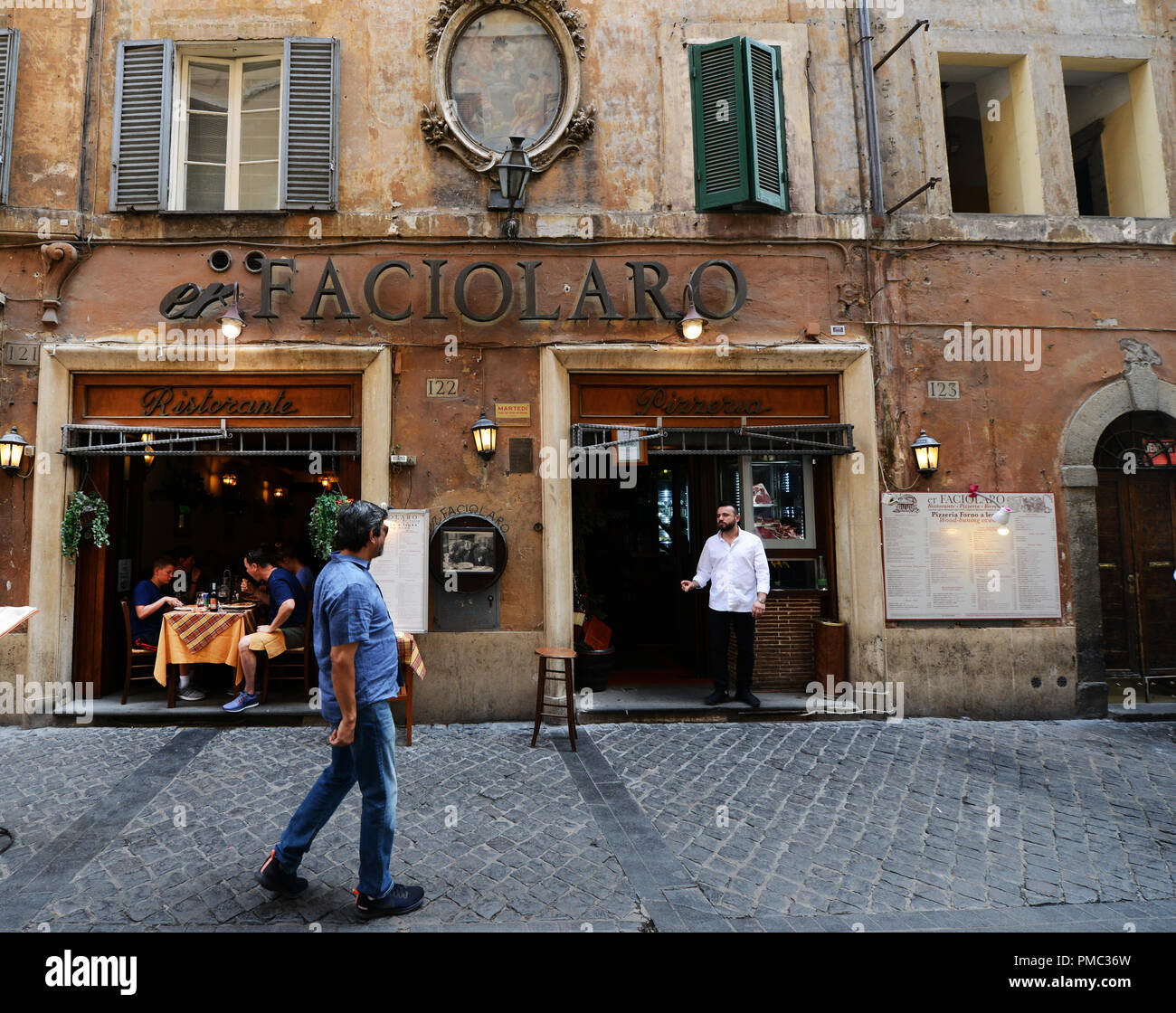 Via dei Pastini pedestrian street and er Faciolaro restaurant. Stock Photo