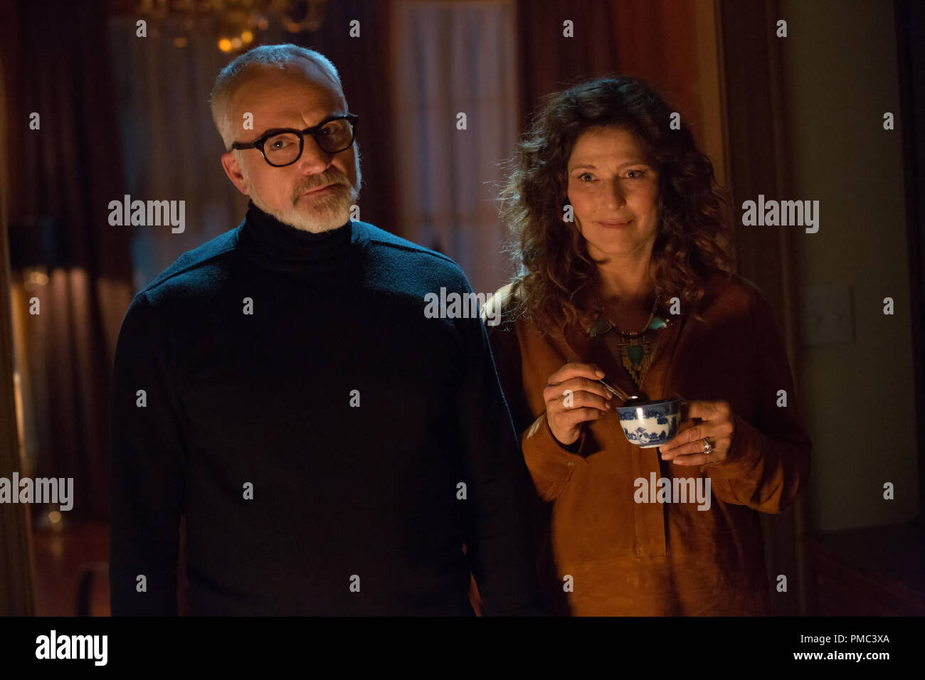 Drs. Dean (BRADLEY WHITFORD) and Missy Armitage (CATHERINE KEENER) in Universal Pictures’ “Get Out,” a speculative thriller from Blumhouse.  When a young African-American man visits his white girlfriend’s family estate, he becomes ensnared in a more sinister real reason for the invitation. (2017) Stock Photo