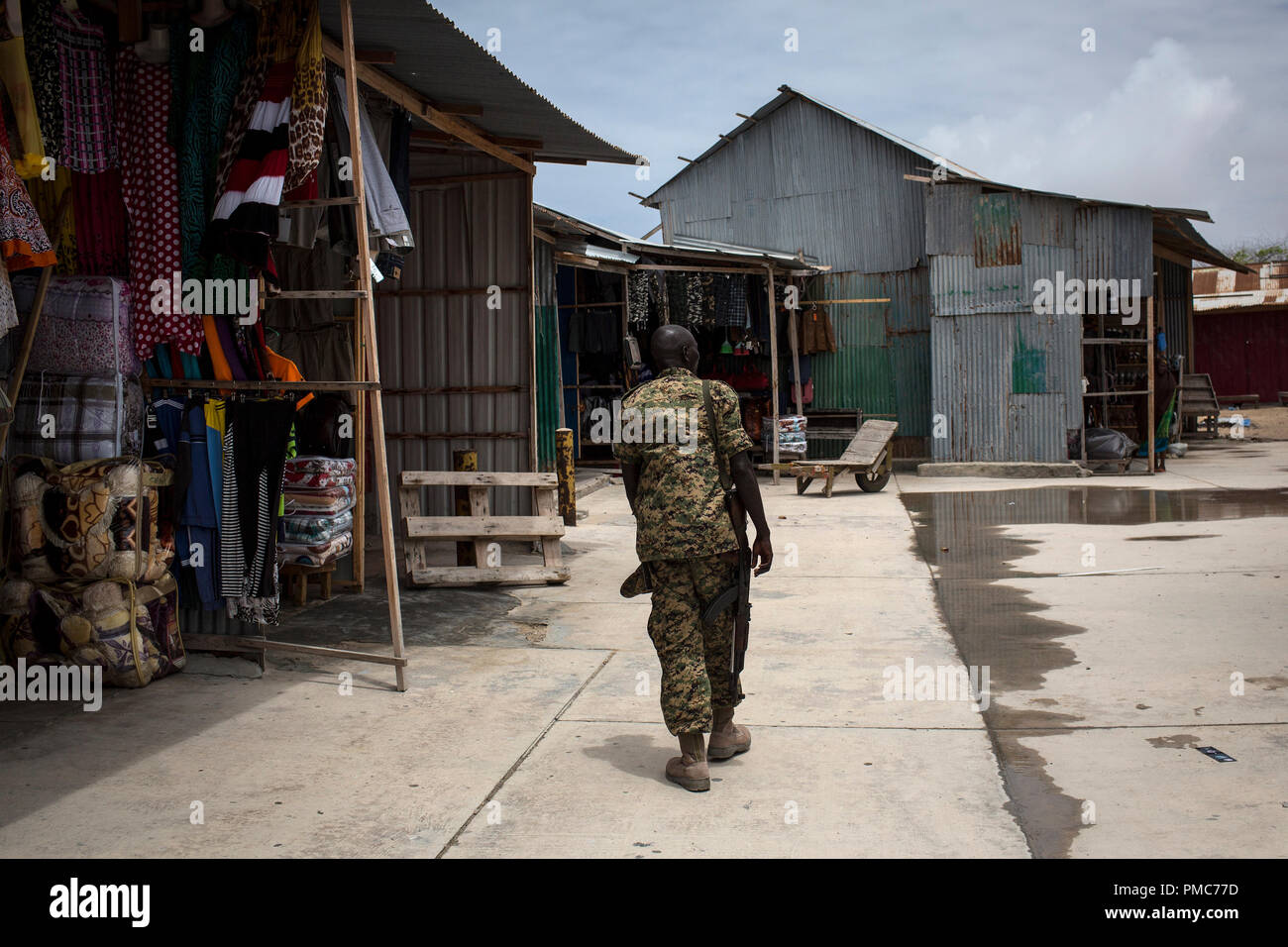 An African Union soldiers walks through  the market of the airport, inside the African Union Mission in Somalia (AMISOM) base in Mogadishu, Somalia, A Stock Photo