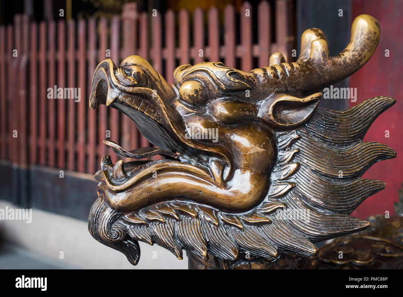 Golden color dragon head scultpure in a buddhist temple, China Stock Photo