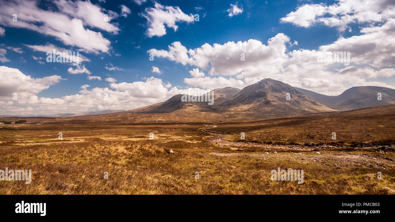 The Black Mount group of mountains, including Stob a' Ghlais Choire and Creise, rise from the bleak peat bog landscape of Rannoch Moor in the West Hig Stock Photo