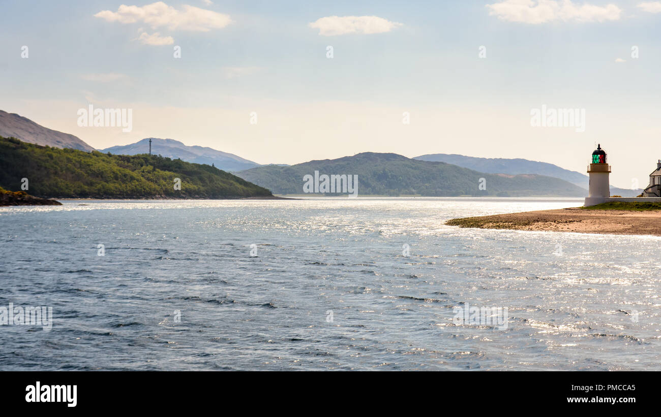 The Ardgour lighthouse guards the narrows at Corran on Loch Linnhe, a sea loch in the Great Glen of the Scottish Highlands. Stock Photo