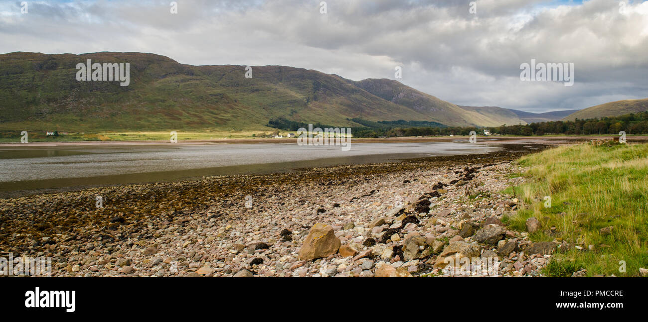 The mountains of the Applecross Peninsula descend to rocky beaches on the shores of the Atlantic Ocean at Applecross village in the west Highlands of  Stock Photo