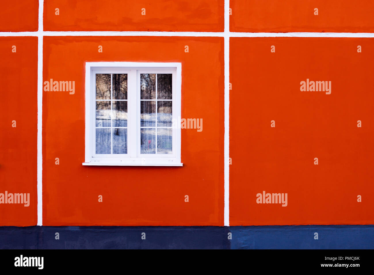 facade of a residential building, a window with a white frame and red ...