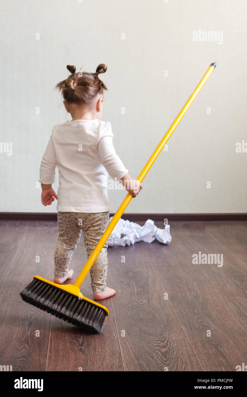 https://c8.alamy.com/comp/PMCJFW/the-child-stands-with-his-back-to-the-camera-holds-the-broom-in-his-hands-and-looks-at-the-garbage-PMCJFW.jpg