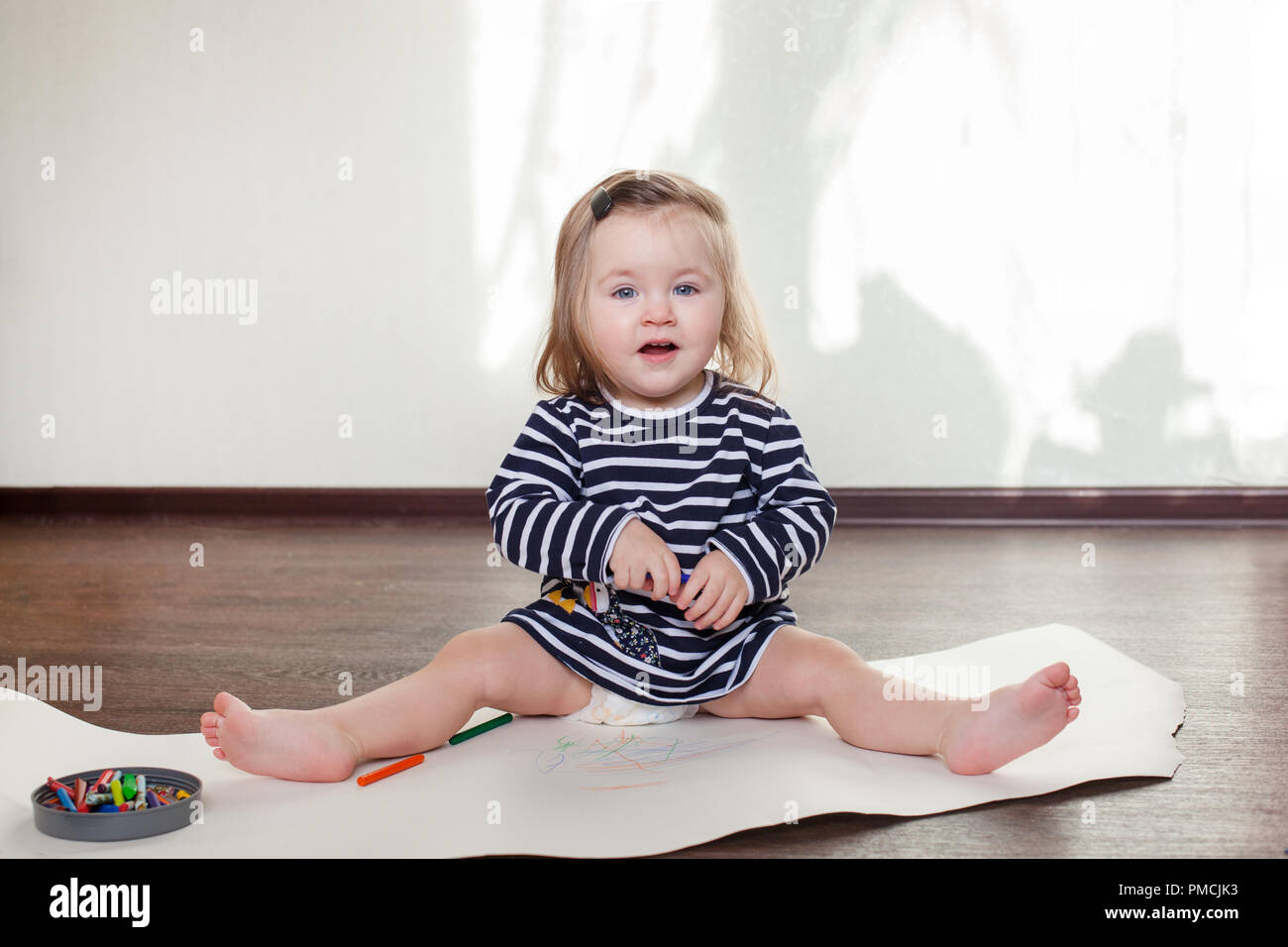 the child learns to draw wax crayons, sits on the floor Stock Photo Alamy