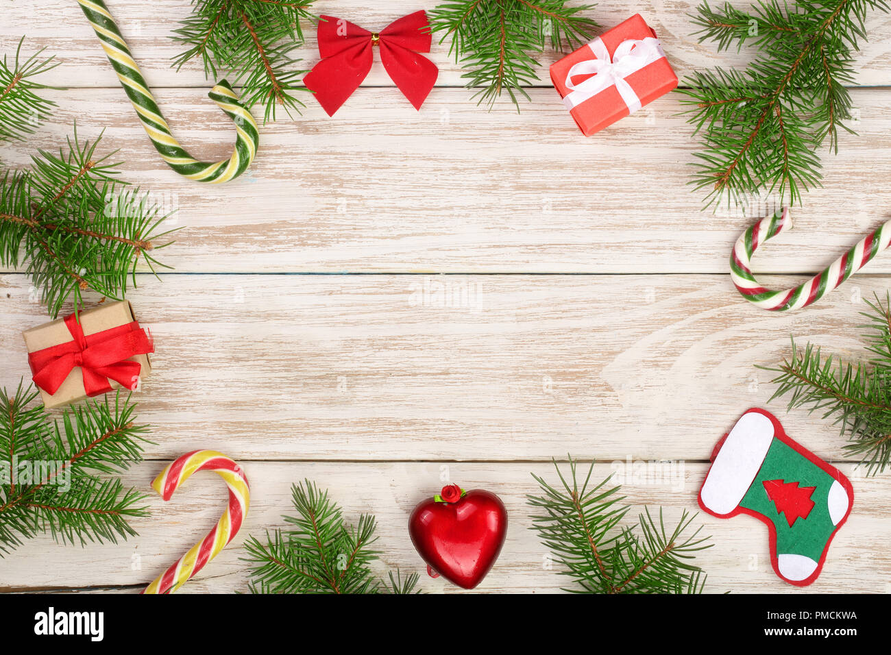Christmas frame made of fir branches decorated with candy canes and ...