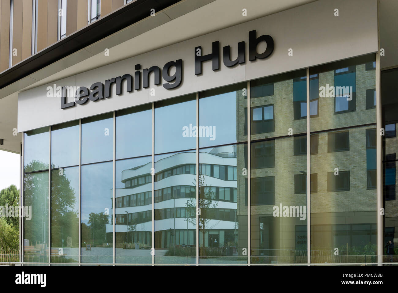Frontage of the Learning Hub, with reflections of the Creative Hub, Waterside Campus, University of Northampton, Northampton, Northamptonshire, UK Stock Photo
